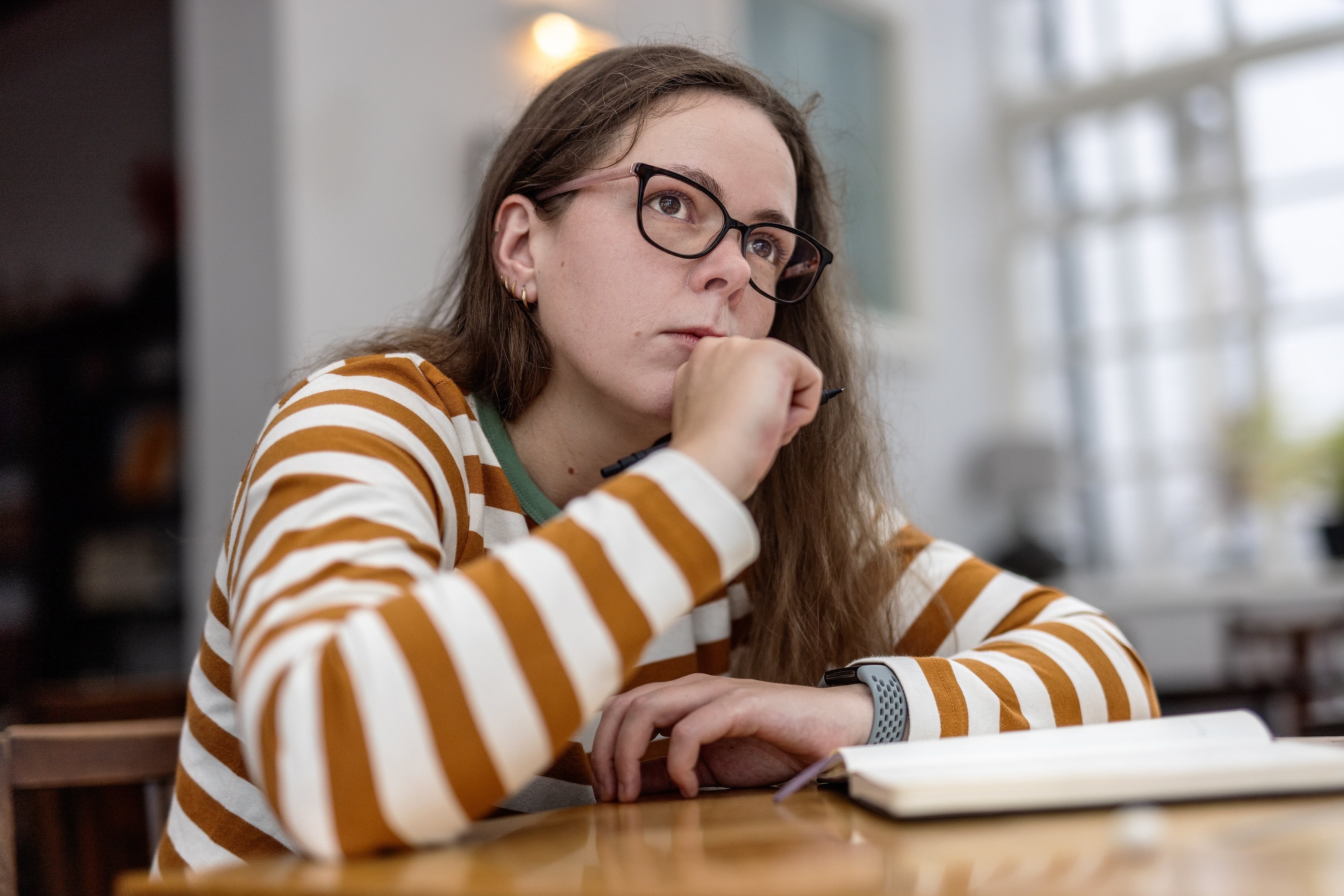 Bethan Morgan-Williams looking into the distance over her notebook